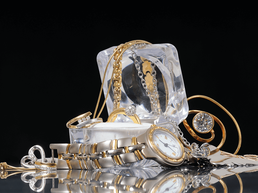 variety of silver and gold and platinum jewelry on black background - Breese, IL