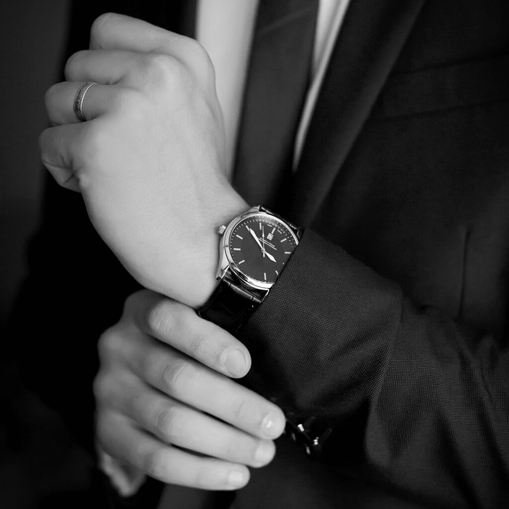 Male jewelry - black and white image of man in suit with expensive watch - Lee's Fine Jewelry - Highland, IL
